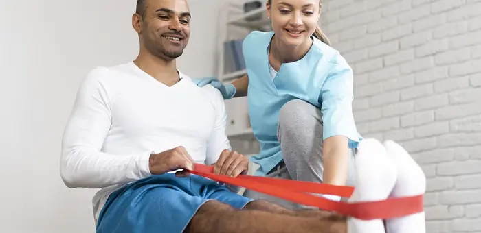 Physiotherapist guiding a patient through resistance band exercise